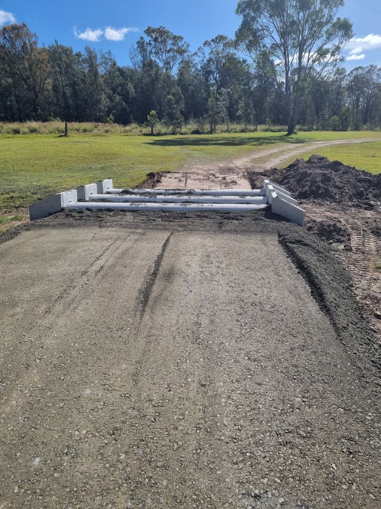 Construction of Concrete Culvert Pipes With Excavator and Worker — Hunter Valley Bitumen in Gresford, NSW