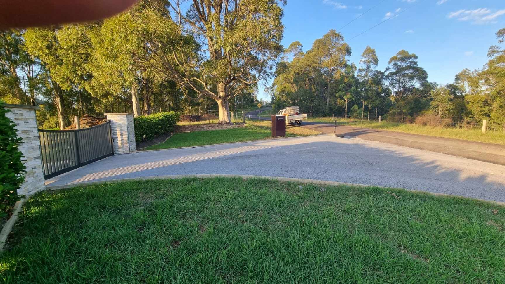 Residential Driveway Entrance With Automatic Gate and Paved Crossover — Hunter Valley Bitumen in Gresford, NSW