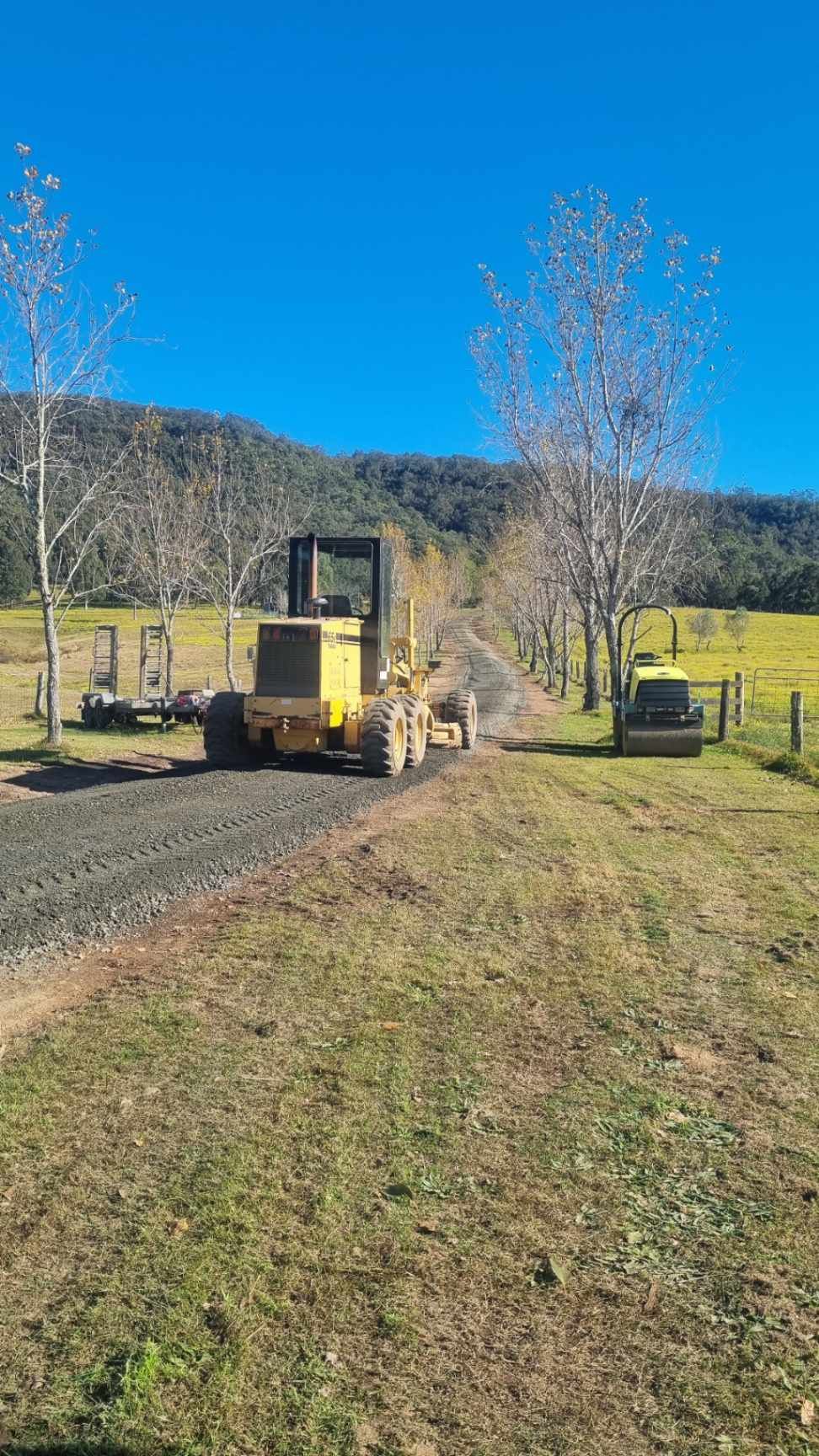 Construction of Concrete Culvert Pipes With Excavator and Worker — Hunter Valley Bitumen in Gresford, NSW