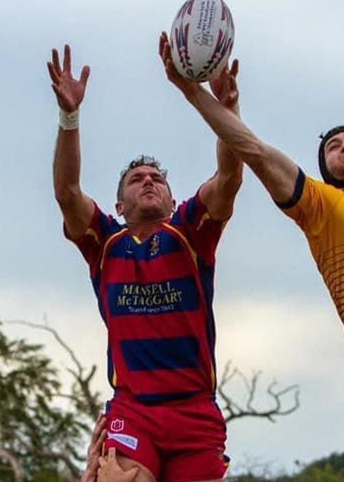 A man in a red and blue jersey that says mcfarlane on it