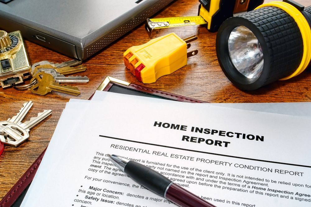 A home inspection report is sitting on a wooden table.