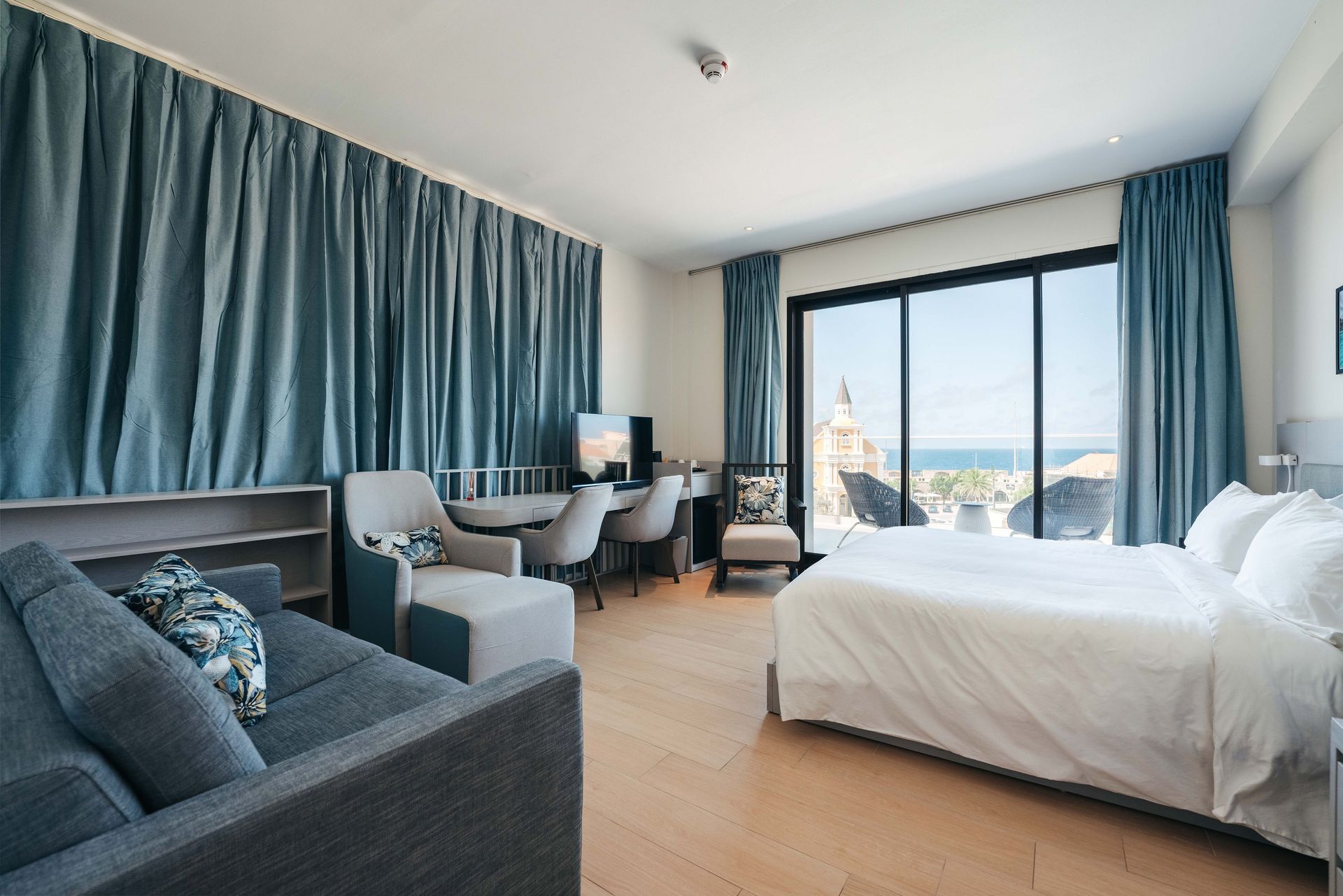 A hotel room with a large bed and a couch