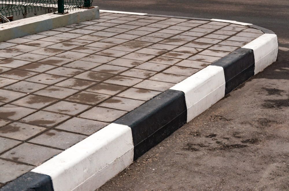 Stylish Black and White Kerb and Gutter Design — Bustin' Free Earthworks in Bathurst, NSW