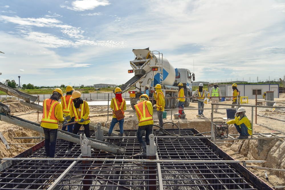 Civil Workers Pouring Concrete into Steel Structure — Bustin' Free Earthworks in Bathurst, NSW