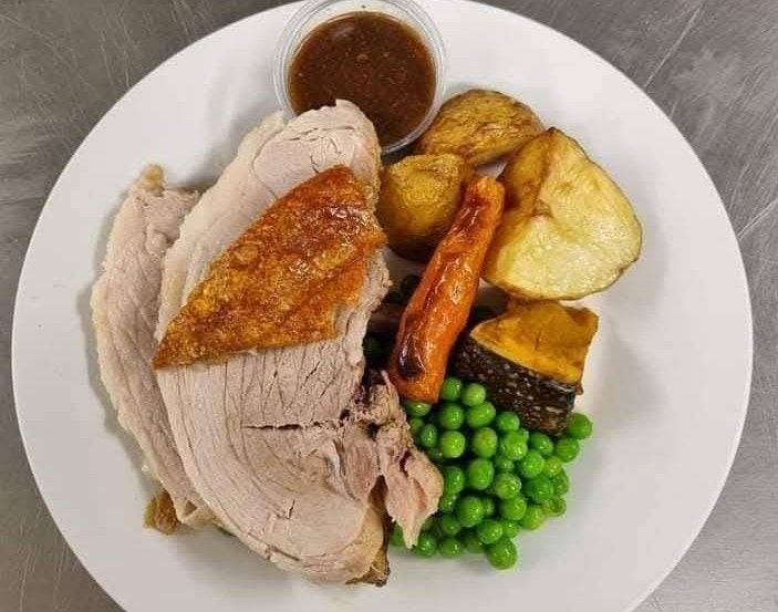 Roast dinner with sliced turkey, potatoes, peas, carrot, and gravy on a white plate — Tre's Carvery in Mount Sheridan, QLD