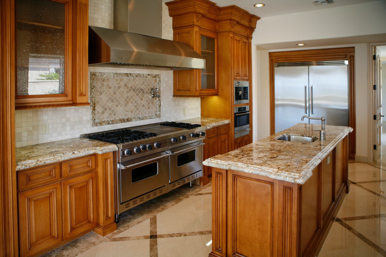 A kitchen with stainless steel appliances and granite counter tops.