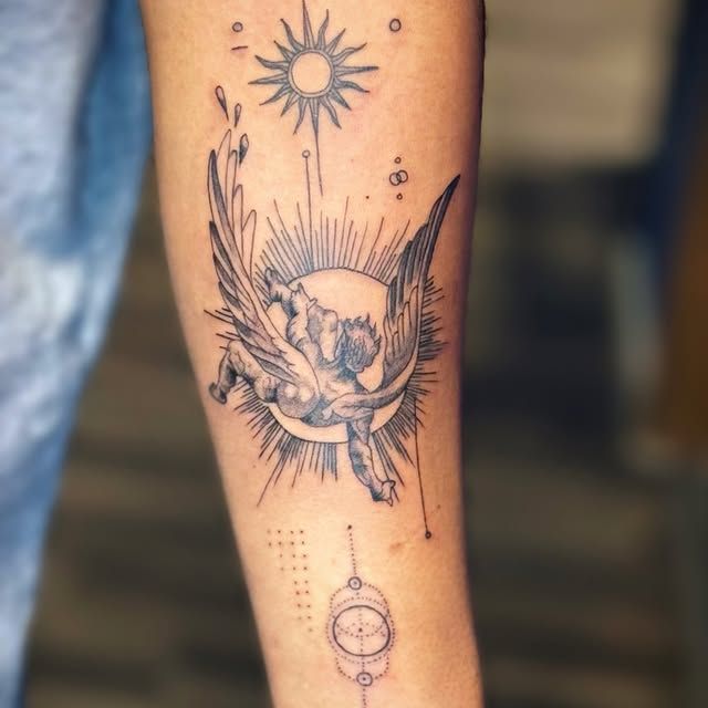 A forearm tattoo featuring a winged figure falling toward a sun, with a small sun above and geometric symbols below.