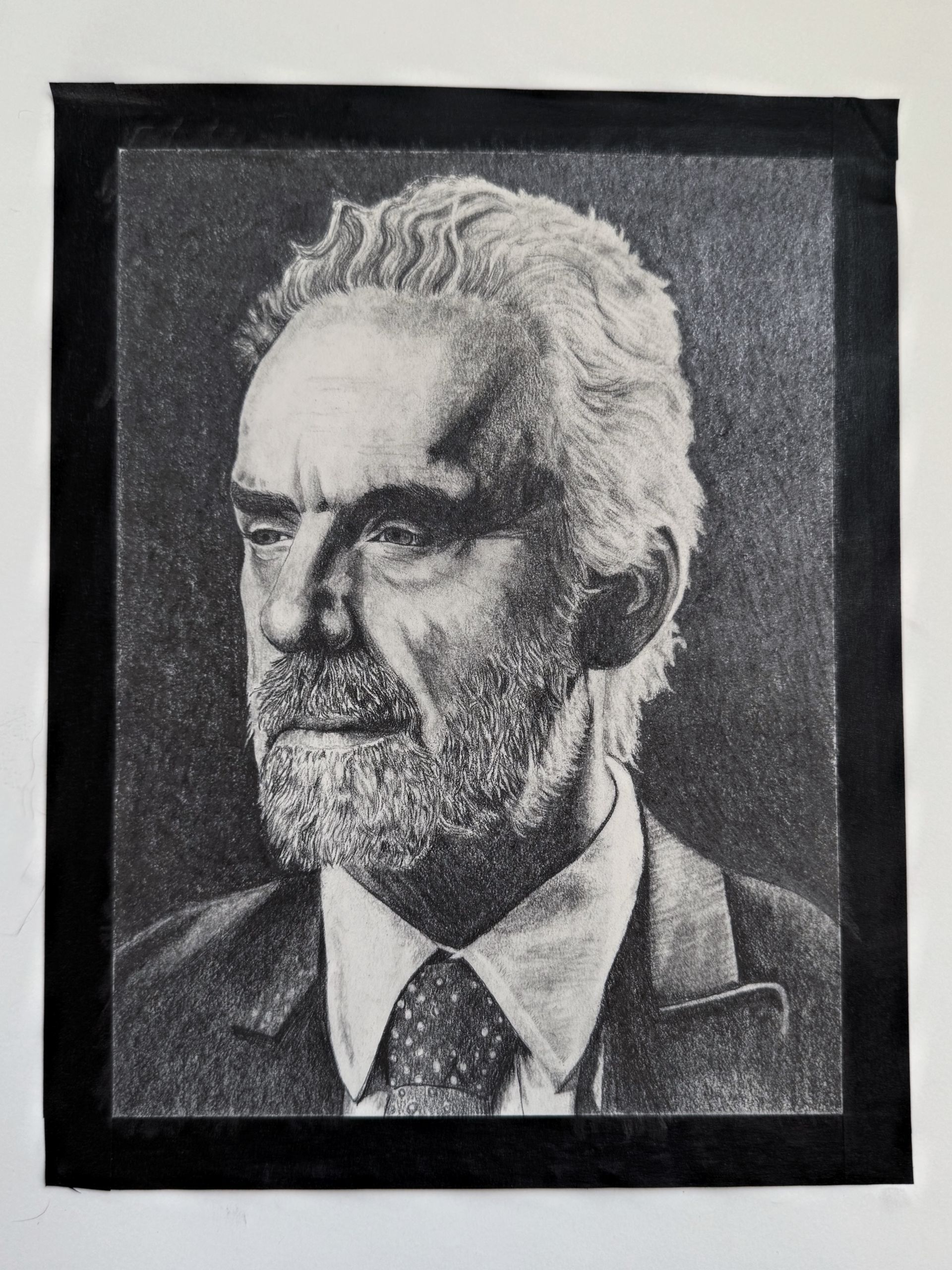 Black-and-white portrait drawing of a bearded man in a suit and tie against a dark background