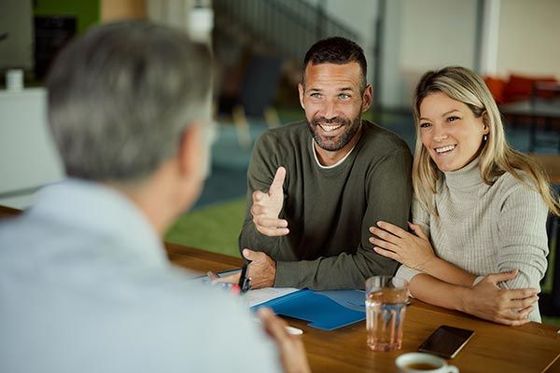 Happy Couple Talking to Their Insurance Agent — Willits, CA — Cantua Insurance Happy Couple Talking to Their Insurance Agent — Willits, CA — Cantua Insurance