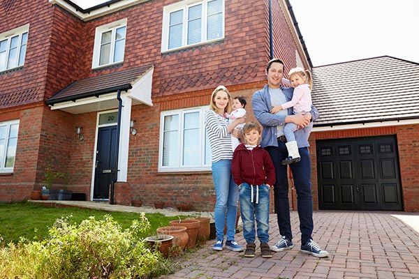 Young Family Standing Outside New Home — Willits, CA — Cantua Insurance