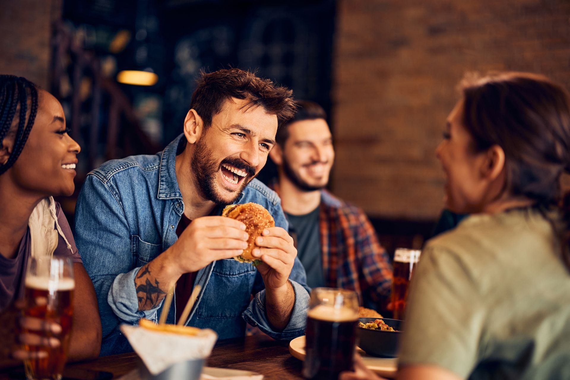 People eating burger and laughing together.