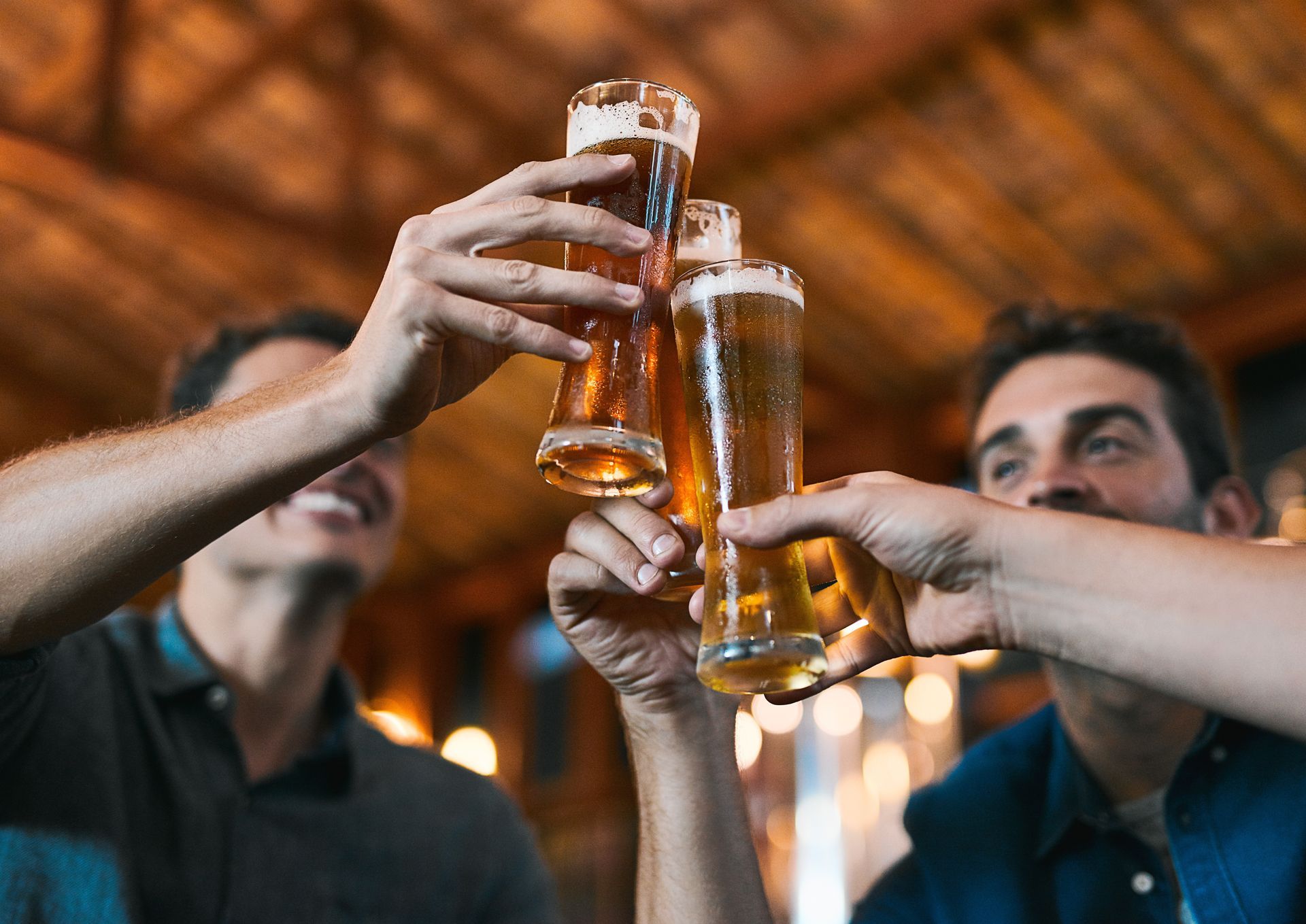 People cheering with beer in their hands.