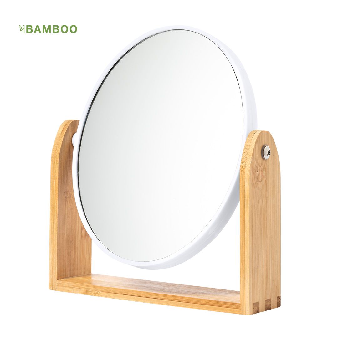 Un espejo de tocador redondo con marco blanco, montado sobre un soporte de madera de bambú de color claro con eje giratorio.