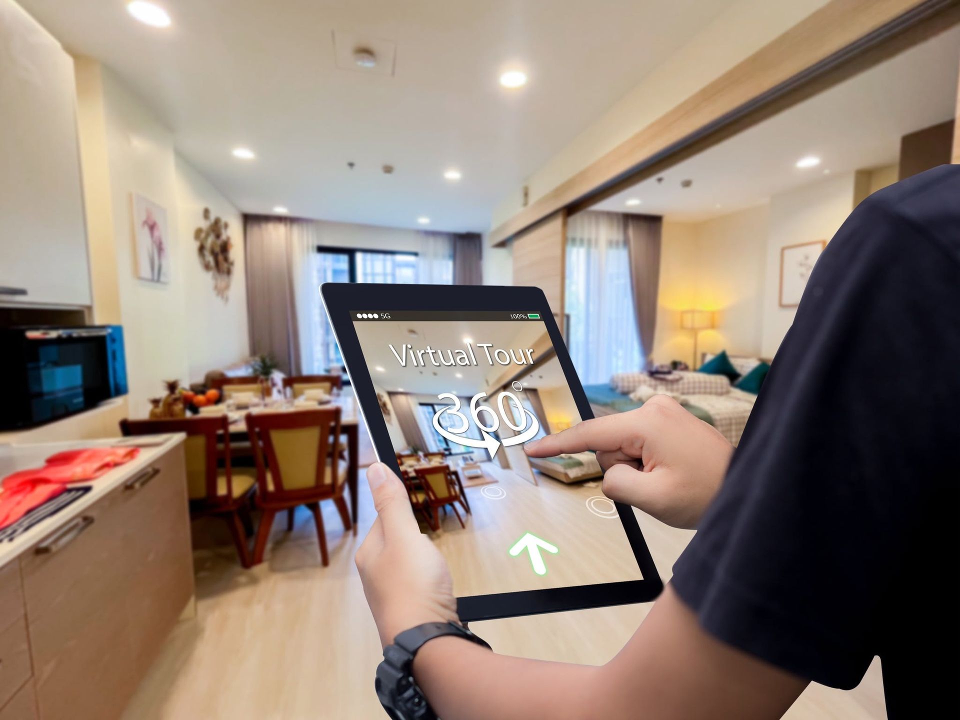 Person using a tablet with a home interior and touchscreen game on the display.