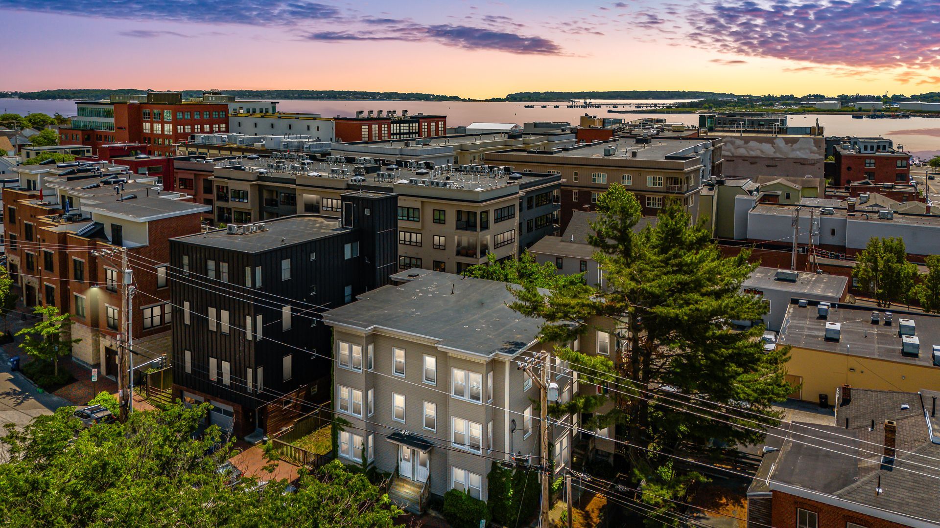 Sunset over a dense downtown neighborhood with brick buildings and city streets