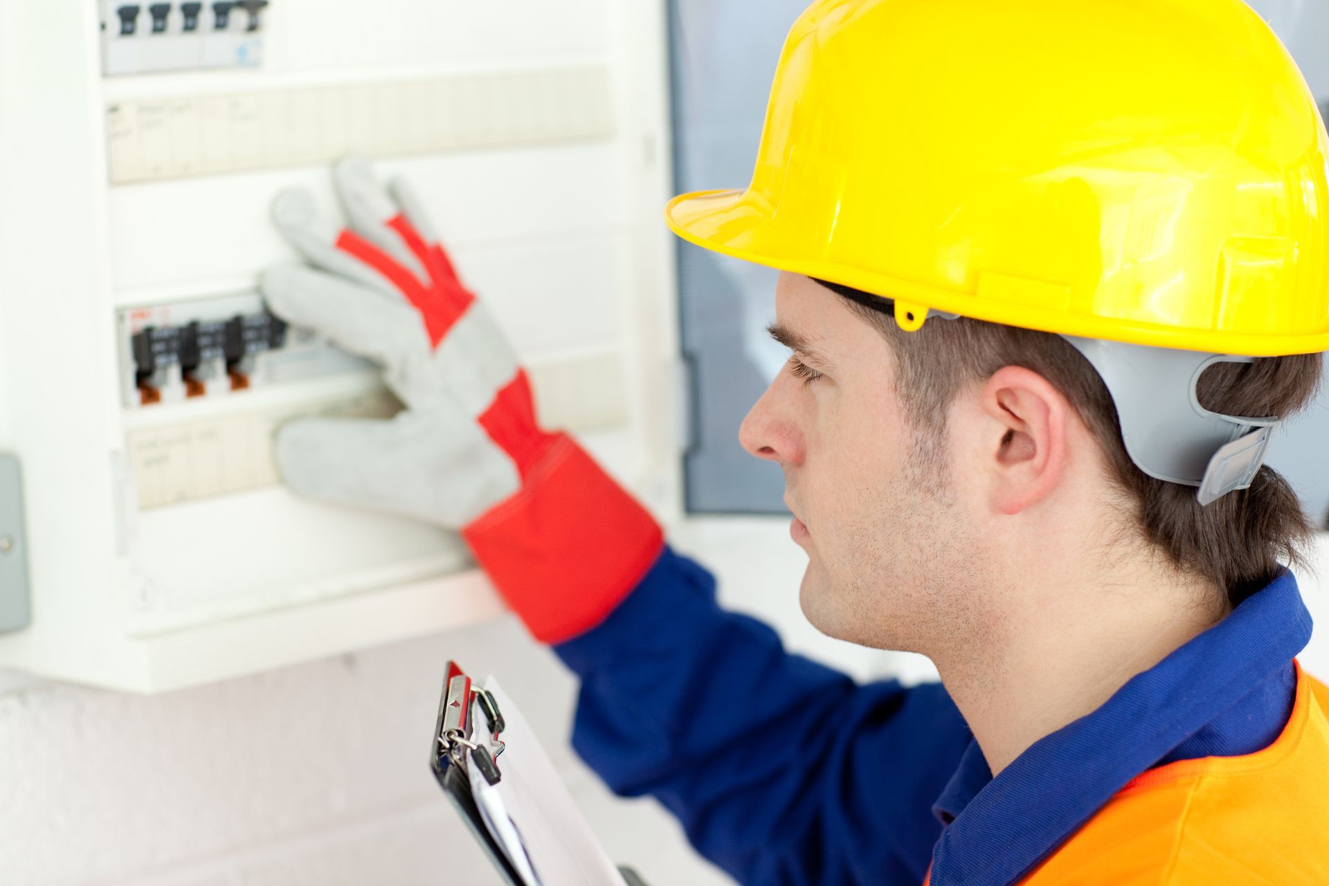 Electrician repairing a power panel while showcasing expert electrical services for safe system.