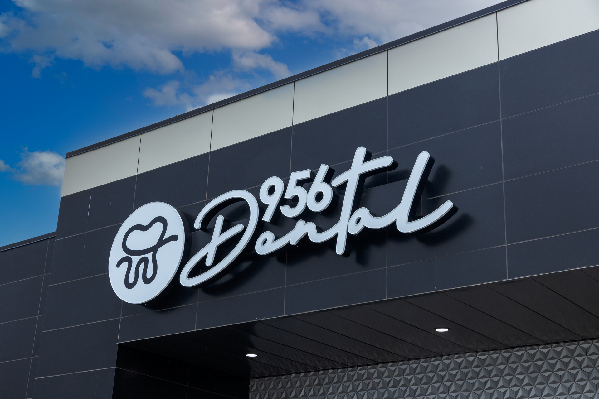 The storefront sign 956 Dental, a dentist office located in Laredo, Texas.