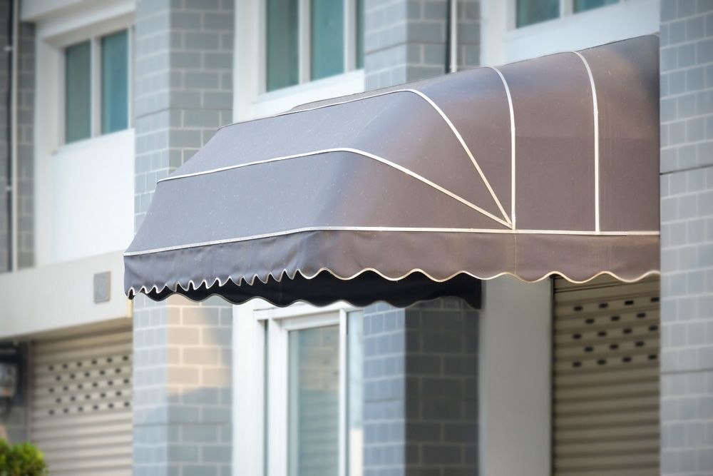 A Gray Awning is on the Side of a Building — Budget Screens & Awnings in South Lismore, NSW