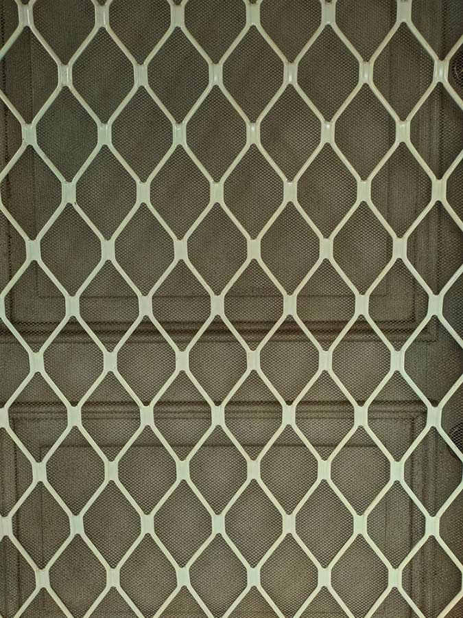 A Close Up of a Chain Link Fence on a Wall — Budget Screens & Awnings in Evans Head, NSW