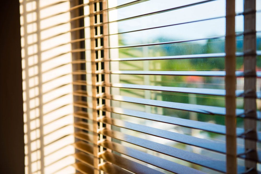 A Close Up of a Window With Blinds on It — Budget Screens & Awnings in Byron Bay, NSW