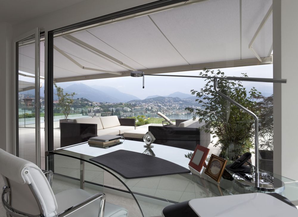 A Living Room With a Couch and a Table With a View of the Mountains — Budget Screens & Awnings in Evans Head, NSW