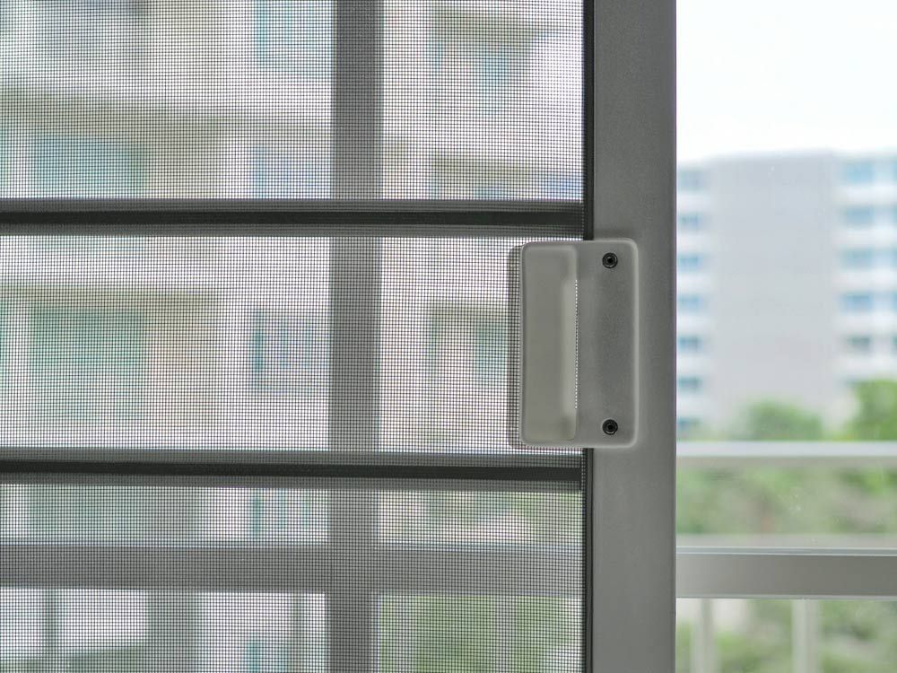 A Close Up of a Sliding Screen Door With a Handle — Budget Screens & Awnings in Casino, NSW
