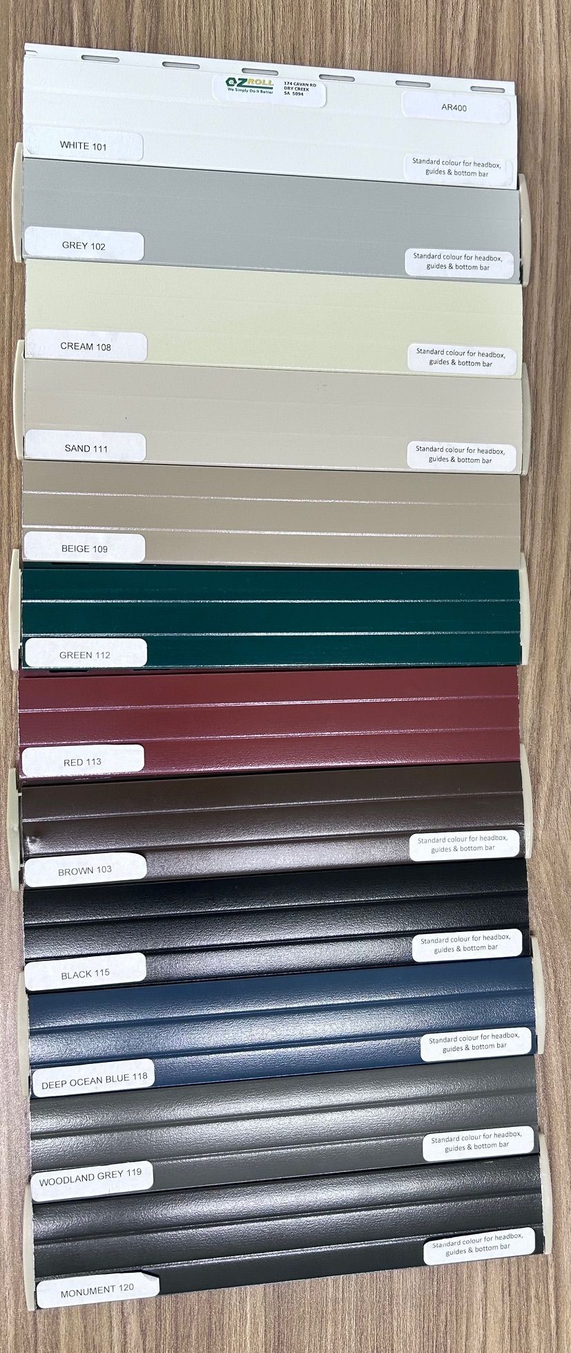 A sample board displaying colors of siding panels in a stacked arrangement — Budget Screens & Awnings in South Lismore, NSW