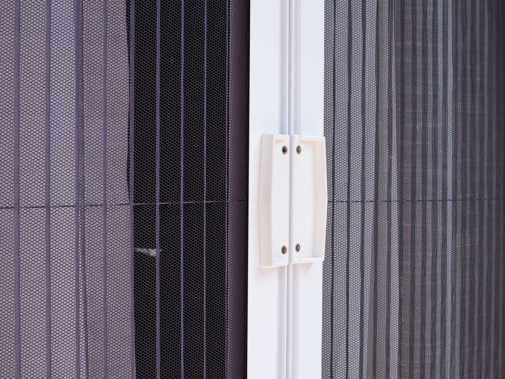 White-framed Retractable Screen Door With Black Mesh — Budget Screens & Awnings in Ballina, NSW