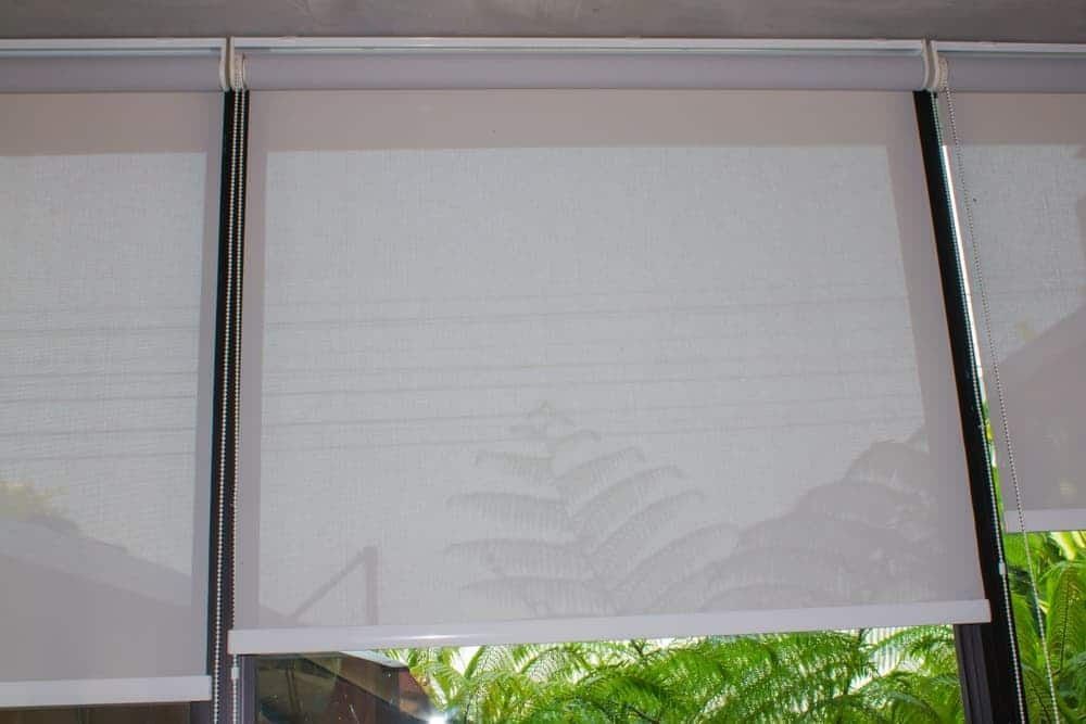 A Close Up of a White Roller Blind on a Window — Budget Screens & Awnings in South Lismore, NSW