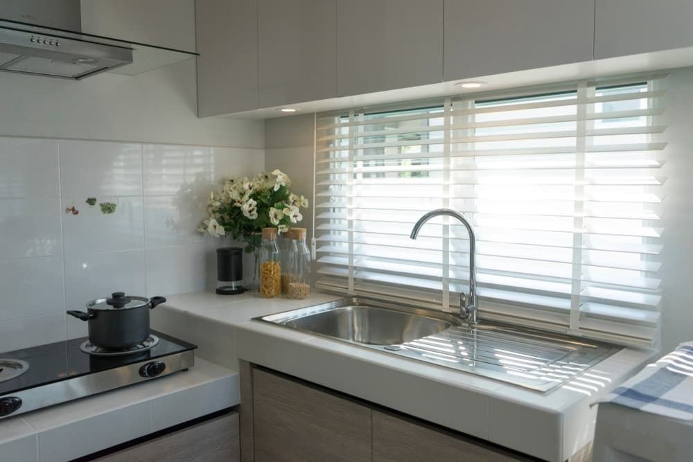A Kitchen With a Pot on the Stove and a Sink — Budget Screens & Awnings in South Lismore, NSW