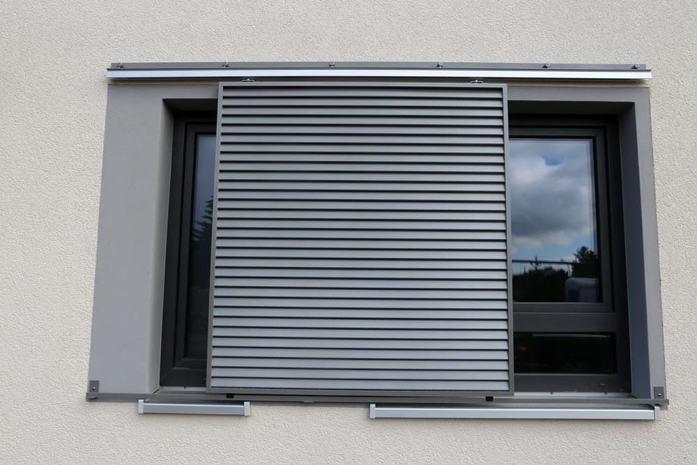 A Window With a Sliding Shutter on It — Budget Screens & Awnings in South Lismore, NSW