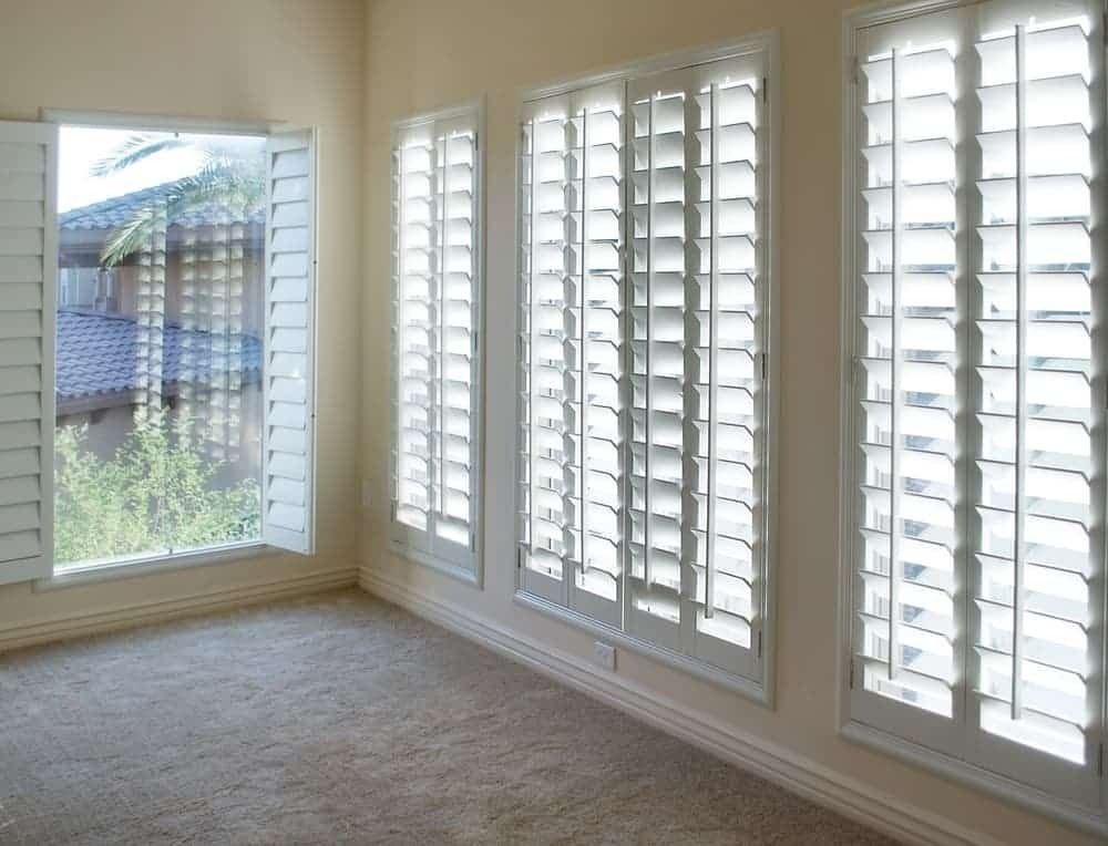 An Empty Room With White Shutters on the Windows — Budget Screens & Awnings in South Lismore, NSW