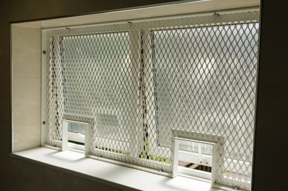 A Window With a Metal Mesh Covering It — Budget Screens & Awnings in South Lismore, NSW