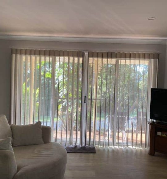 A Living Room With a Couch, Television and Sliding Glass Doors — Budget Screens & Awnings in South Lismore, NSW