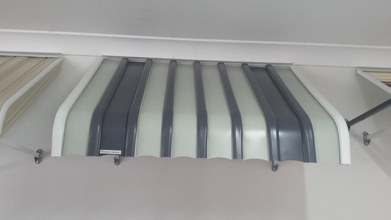 A metal window awning with alternating vertical panels — Budget Screens & Awnings in South Lismore, NSW