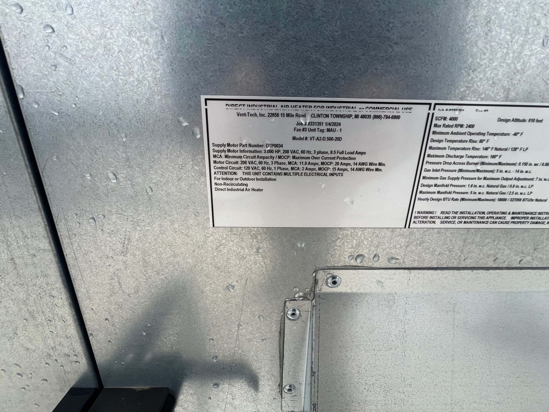Metal surface with a data plate attached by screws.