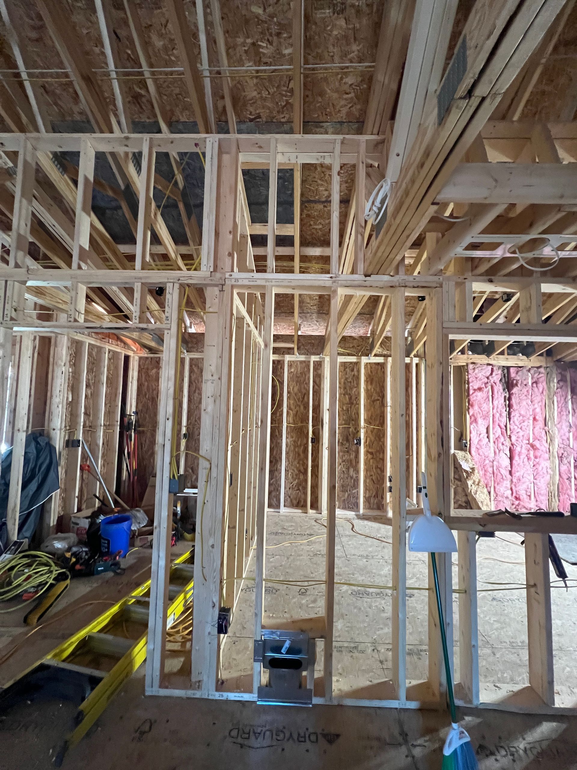 Wooden framing of a room under construction; exposed studs and beams.