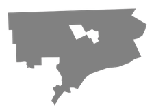 Gray abstract map silhouette with a few white cutout shapes on a white background