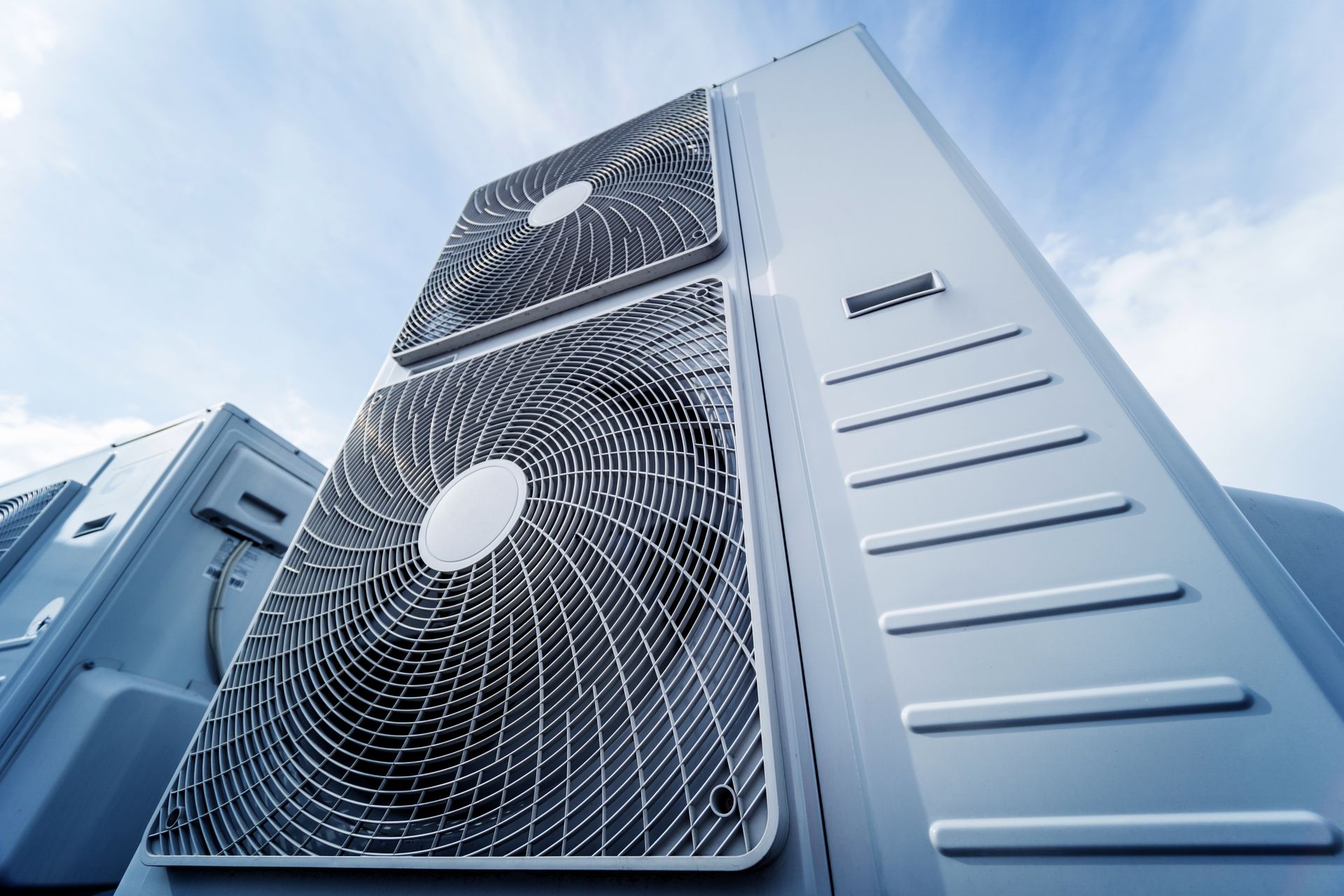 Air conditioning units against a blue sky.