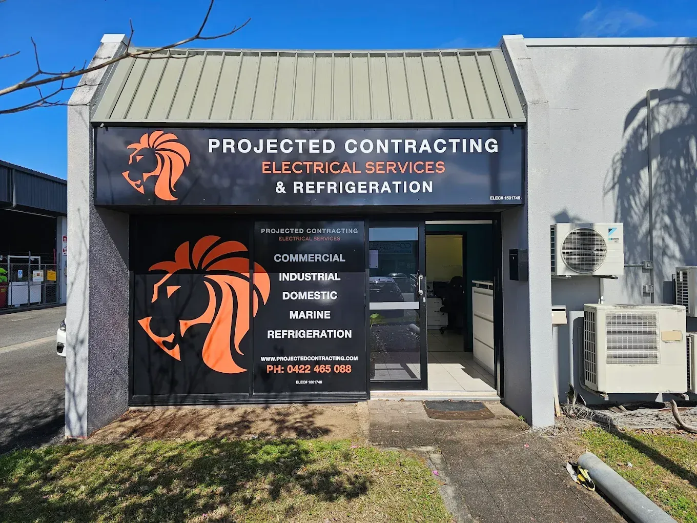 Electrician in Orange Gloves Installing an Electrical Outlet — Projected Contracting Electrical Services In Portsmith, QLD