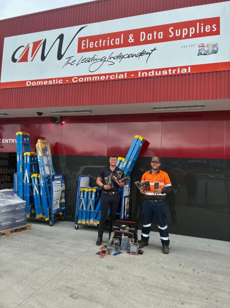 Two Men Pose Outside an Electrical Supply Store โ Projected Contracting Electrical Services In Portsmith, QLD