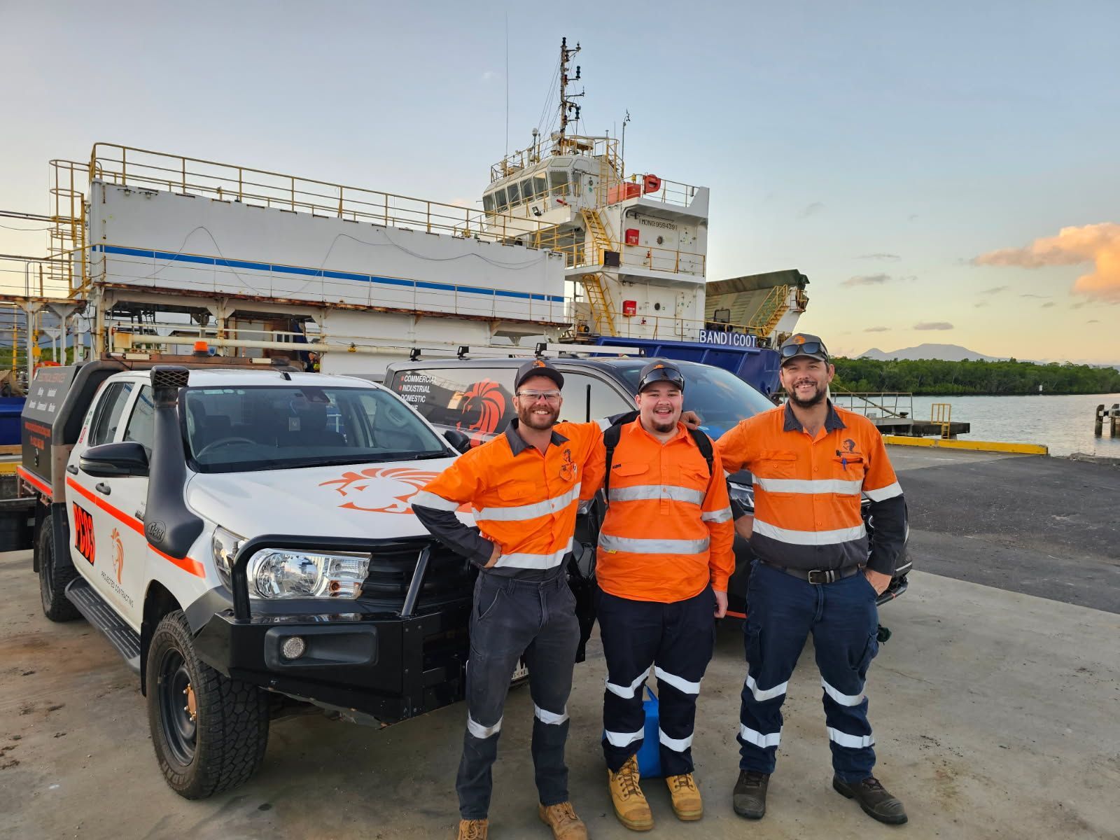Three Workers in Orange Safety Vests — Projected Contracting Electrical Services In Portsmith, QLD