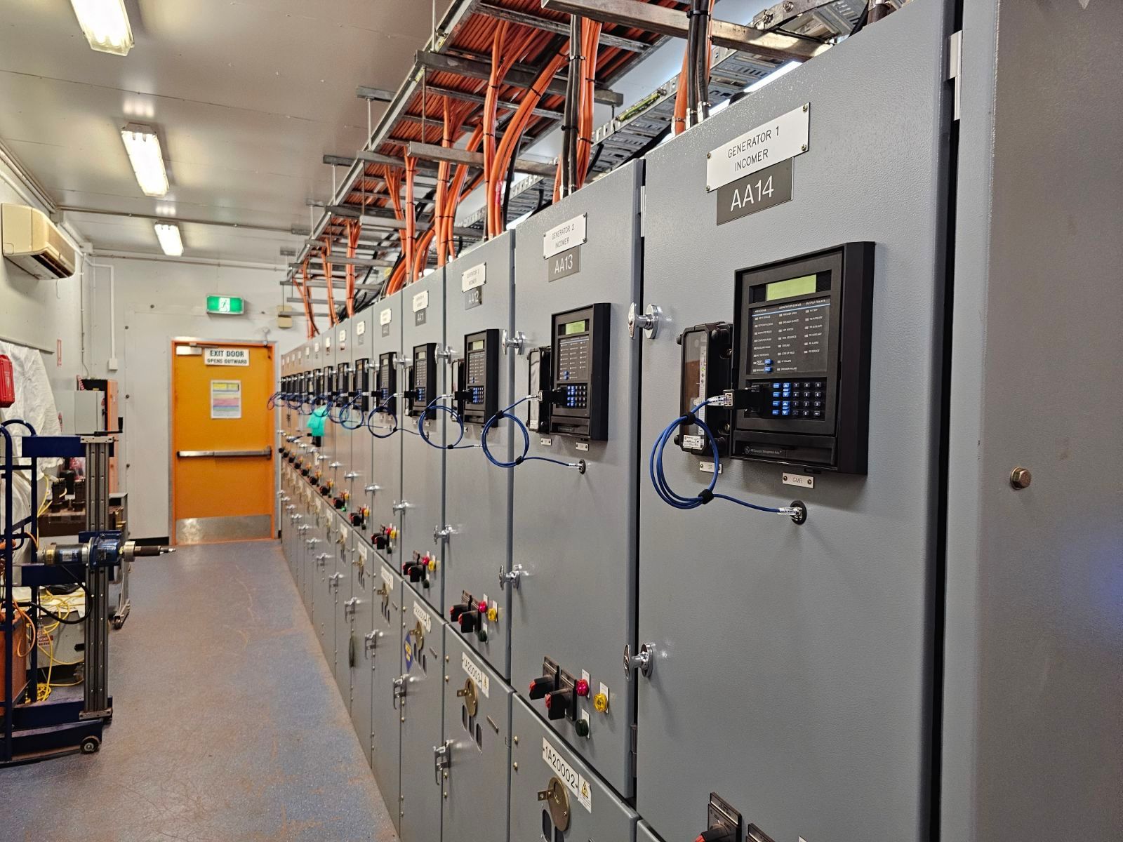 Switch Room With Orange Exit Door — Projected Contracting Electrical Services In Portsmith, QLD