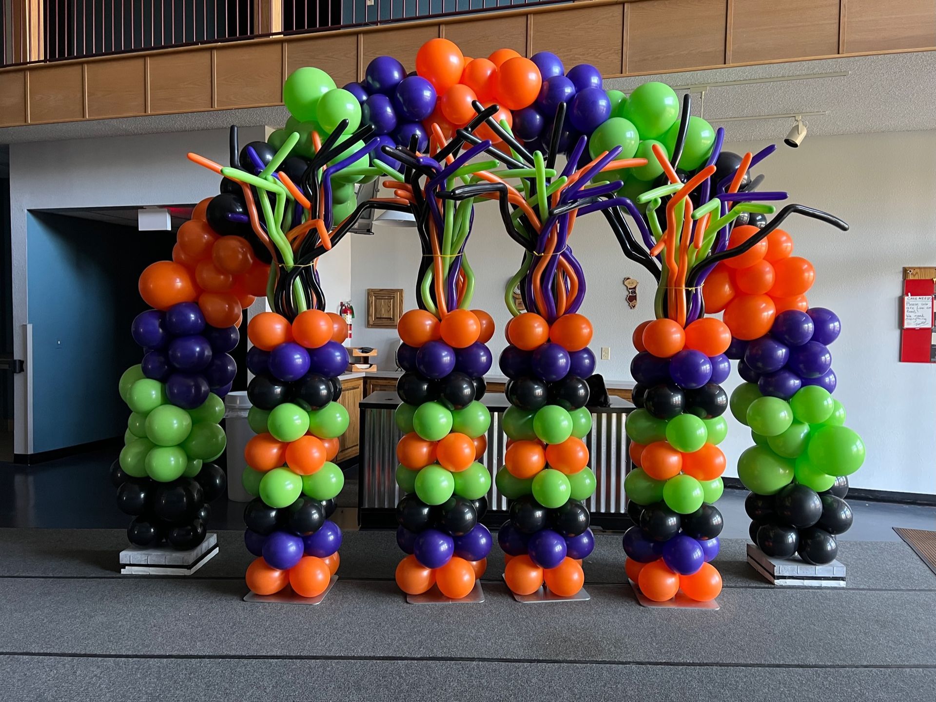 A bunch of balloons are lined up in a room