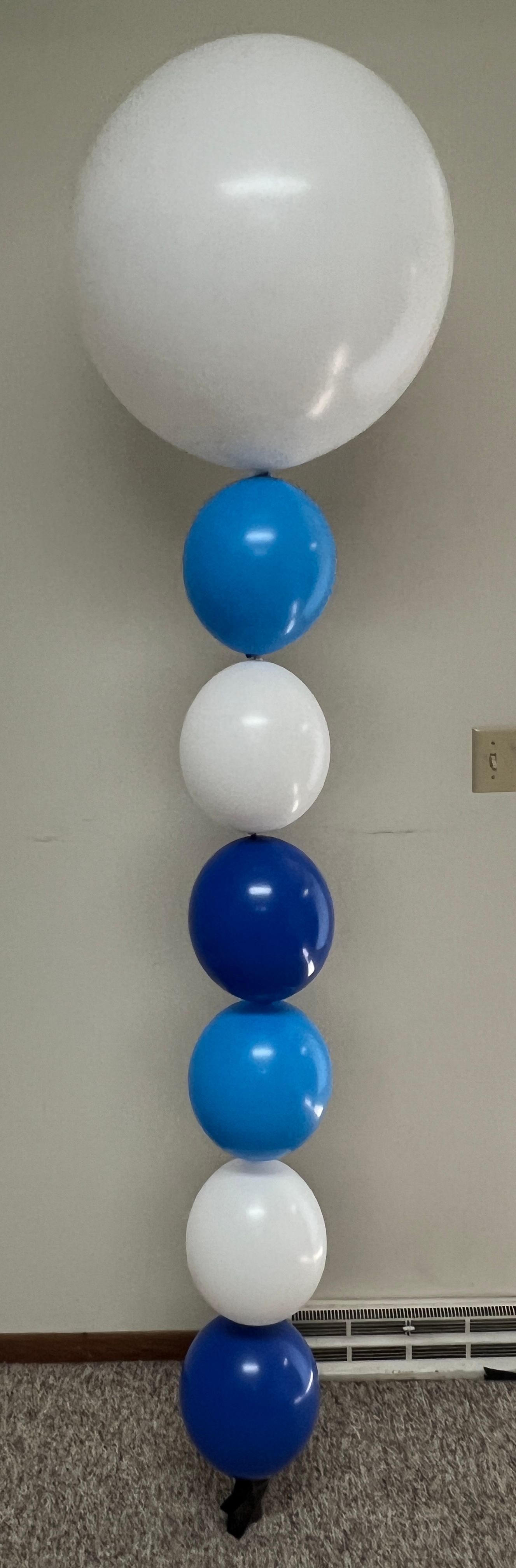 A row of blue and white balloons stacked on top of each other.