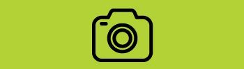 A black and white icon of a camera on a green background.