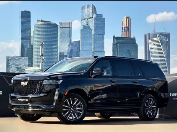 Black Cadillac SUV parked with a city skyline in the background