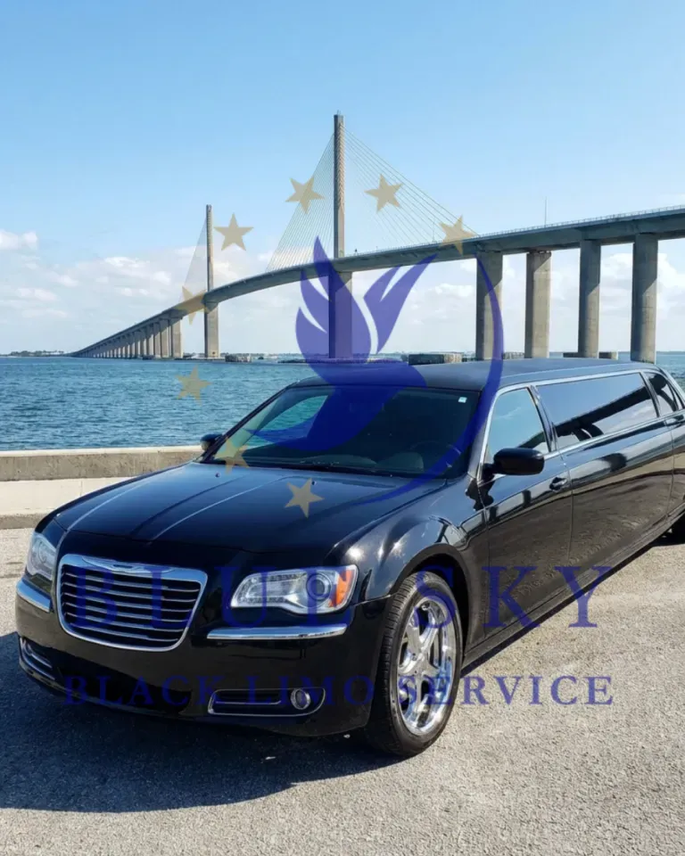 Black limousine parked by a waterfront bridge under a blue sky, with a watermark over the image