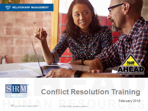 Two people discussing at a table with laptops; banner reads “Conflict Resolution Training”