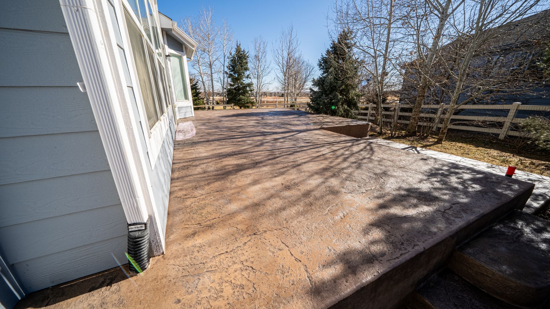 A man is using a machine to finish a concrete floor.
